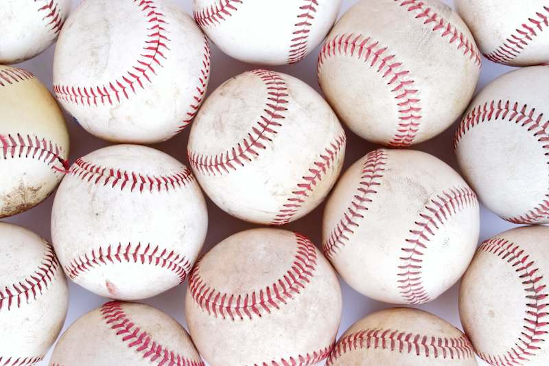 group of baseball balls together on the ground