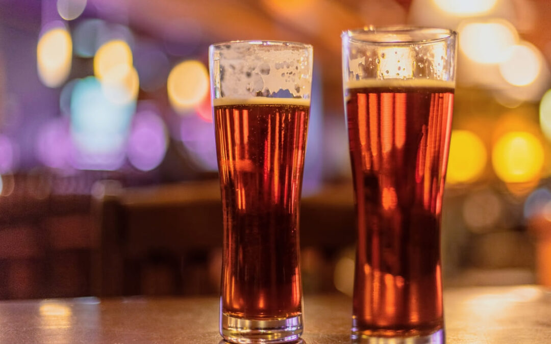 beer glasses sitting on bar top